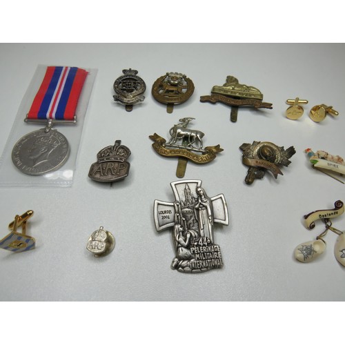 131 - Two silver A.R.P air raid badges, cap badge, medal etc.