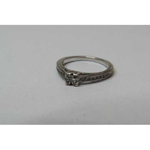 240 - Silver and diamond ring.