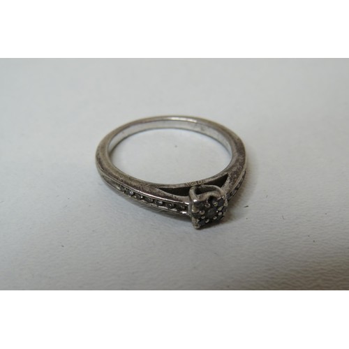 240 - Silver and diamond ring.