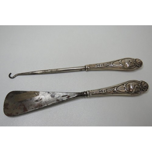 246 - Silver handled shoe horn and button hook.