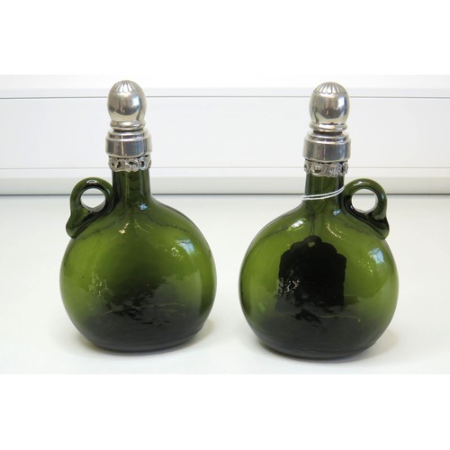 1 - A pair of Vintage green glass Flagon/Decanter bottles with white metal collars and stoppers.