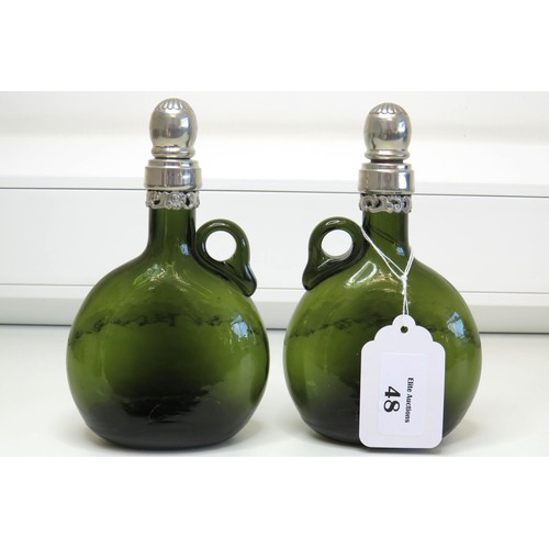 1 - A pair of Vintage green glass Flagon/Decanter bottles with white metal collars and stoppers.