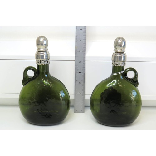 1 - A pair of Vintage green glass Flagon/Decanter bottles with white metal collars and stoppers.