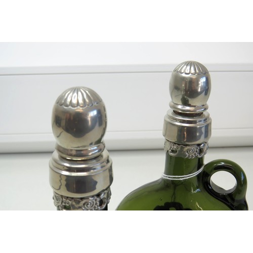 1 - A pair of Vintage green glass Flagon/Decanter bottles with white metal collars and stoppers.