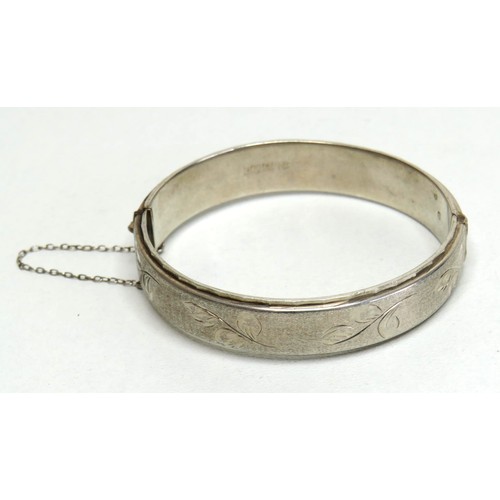 119 - Silver hinged bangle with safety chain.