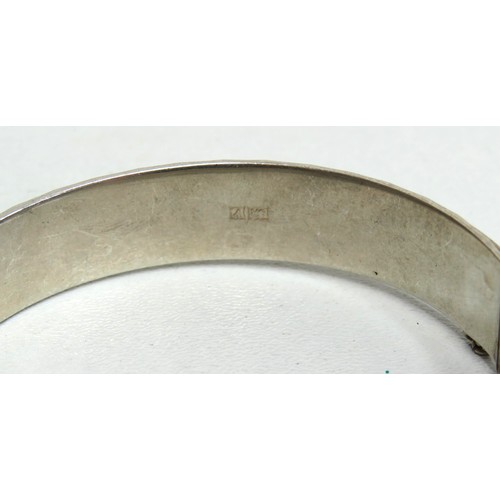 119 - Silver hinged bangle with safety chain.