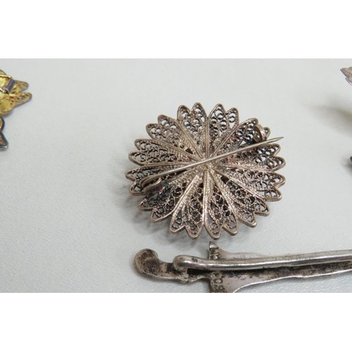 127 - Five silver brooches