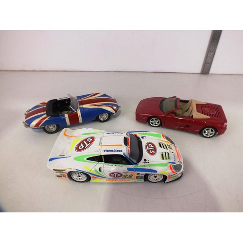 85 - Three 1/18 scale model cars.