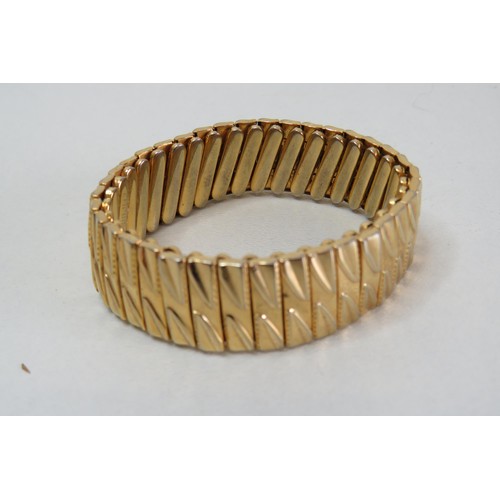 213 - Empire made gold plated stretch bangle.