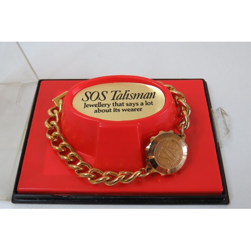 226 - Gold Tone SOS Talisman.