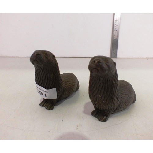 291 - A pair of bronzed resin otter's.