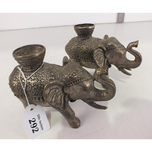 292 - A pair of Asian metal elephant candle holders.