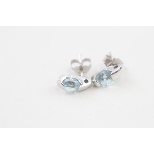 511 - 9ct gold blue topaz earrings with scroll backs (2.6g)