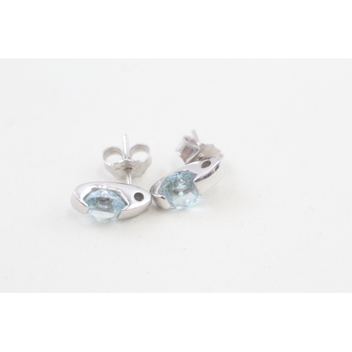 511 - 9ct gold blue topaz earrings with scroll backs (2.6g)