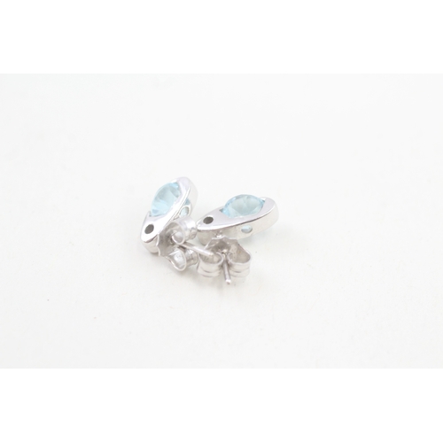 511 - 9ct gold blue topaz earrings with scroll backs (2.6g)