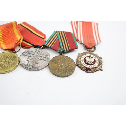 574 - Six Medals Including WW2 German Merit Cross with Swords, Polish & Russian