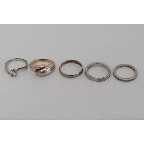 235 - Four silver rings and a white metal ring