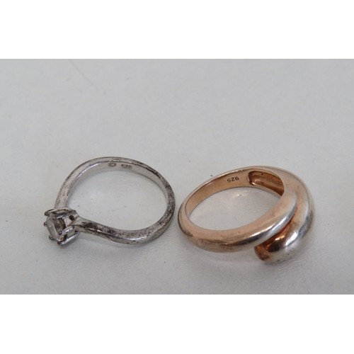 235 - Four silver rings and a white metal ring