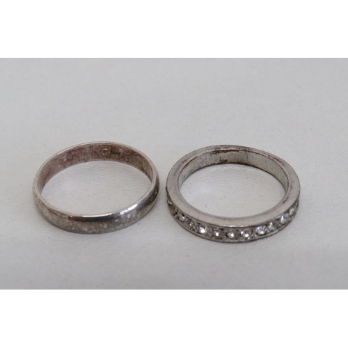 235 - Four silver rings and a white metal ring