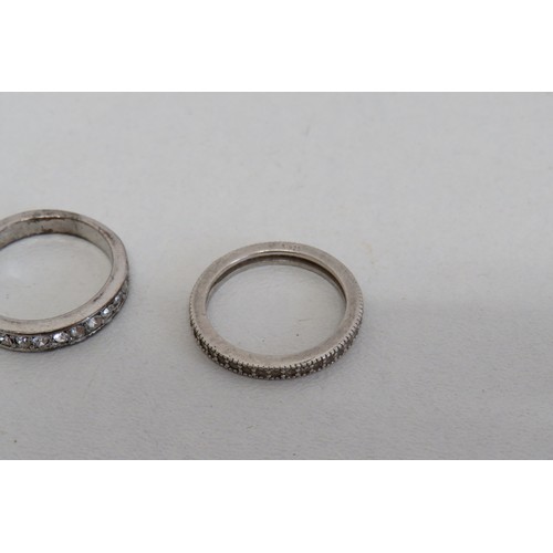 235 - Four silver rings and a white metal ring