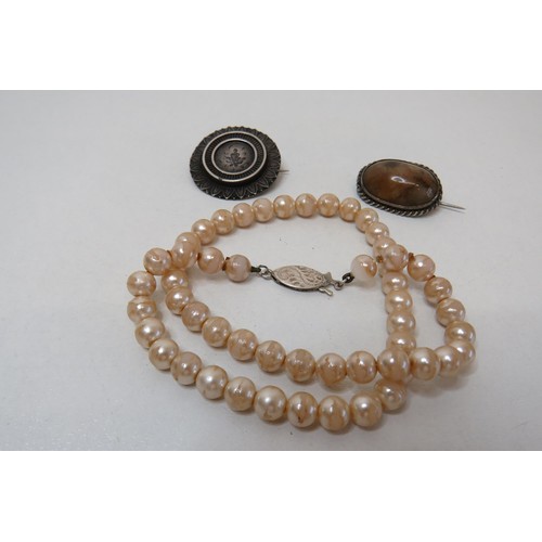 243 - Two silver brooches and a faux pearl necklace with silver clasp.