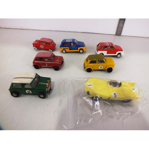 325 - Seven vintage Scalextric cars.