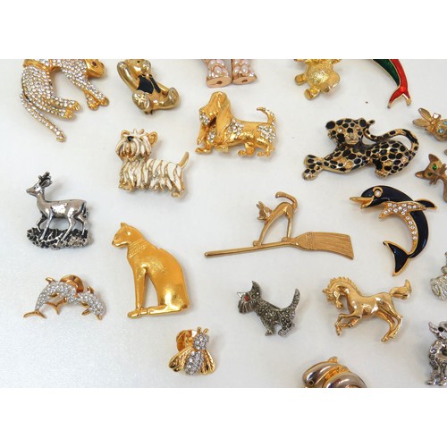 272 - Twenty three assorted brooches including dolphins, animals, teddies and a large gold tone teddy bear... 