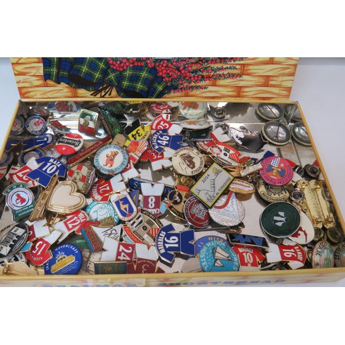 43 - 100 Badges in old tin, magpie, football, curling etc