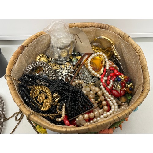 28 - Basket of jewellery and trinkets including vintage brooches, belt buckles etc.