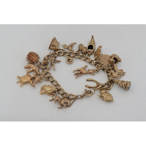 1 - Vintage 9ct gold charm bracelet with twenty 9ct gold charms including opening church and wishing wel... 