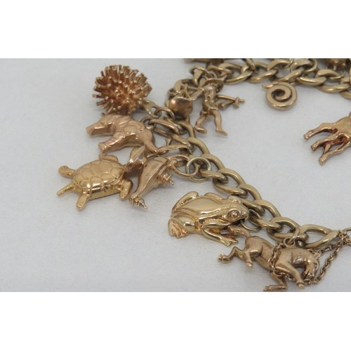 1 - Vintage 9ct gold charm bracelet with twenty 9ct gold charms including opening church and wishing wel... 