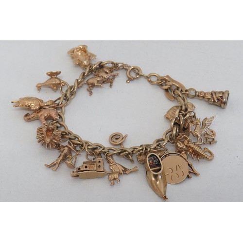 1 - Vintage 9ct gold charm bracelet with twenty 9ct gold charms including opening church and wishing wel... 