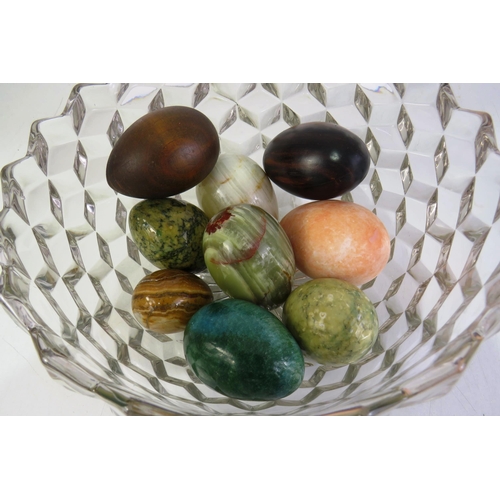 125 - Cut glass fruit bowl full of decorative eggs  including gemstone and treen