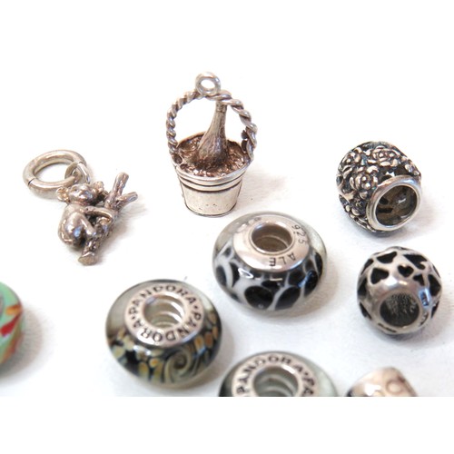 230 - Sixteen 925 Silver charm beads including genuine Pandora.