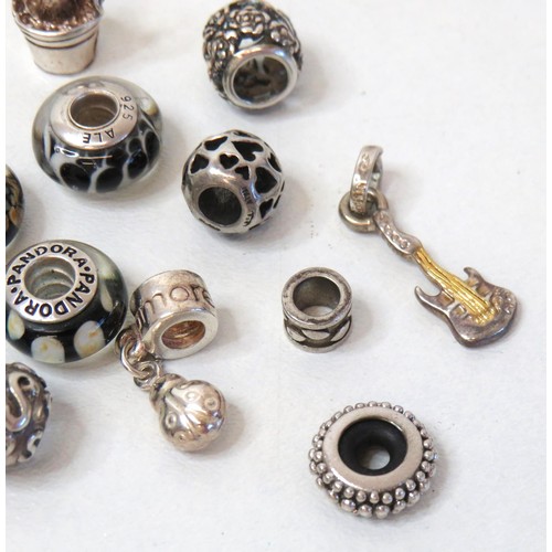 230 - Sixteen 925 Silver charm beads including genuine Pandora.