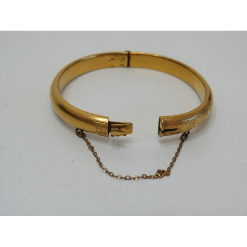 100 - Vintage hinged opening gold colour bangle with safety chain.