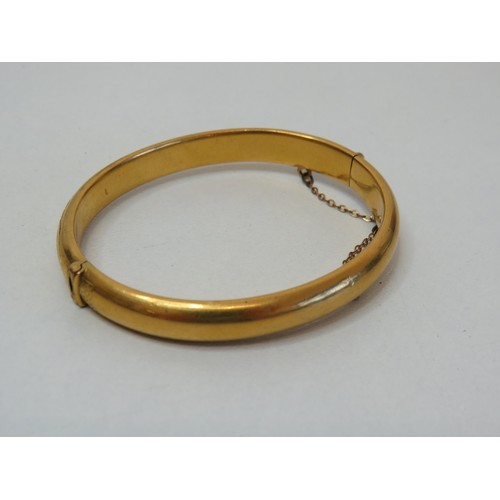 100 - Vintage hinged opening gold colour bangle with safety chain.