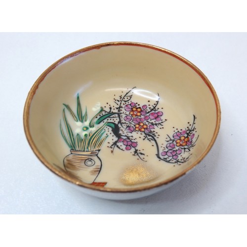 74 - A pair of Japanese hand painted Earthenware Saki cups.