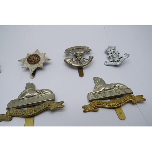 34 - 15 Military Cap/Regiment Badges