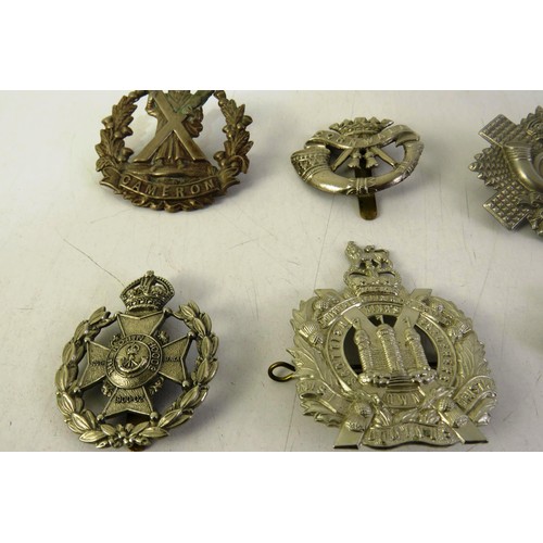 535 - Twelve military cap badges