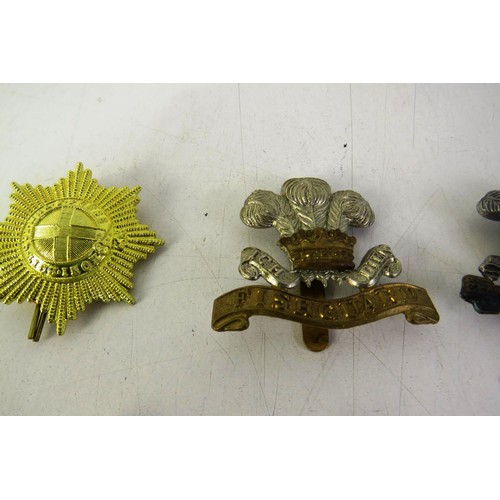 539 - Twelve military cap/ collar badges