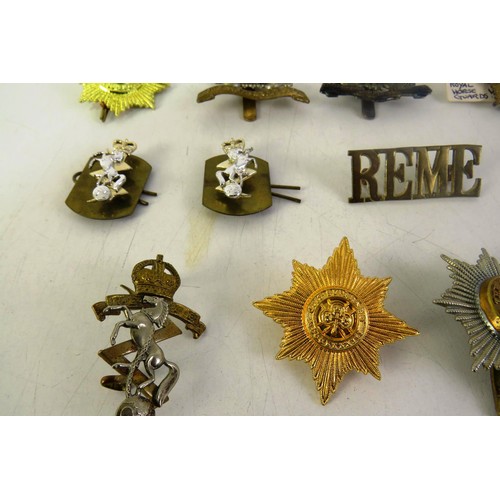 539 - Twelve military cap/ collar badges