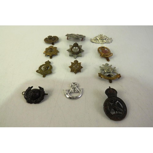 540 - Twelve military cap badges