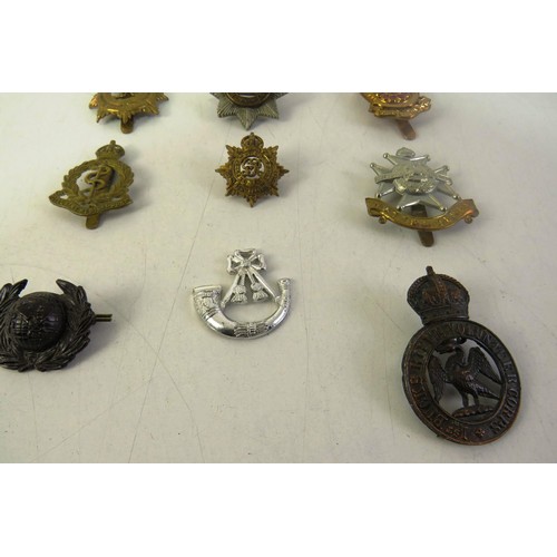 540 - Twelve military cap badges