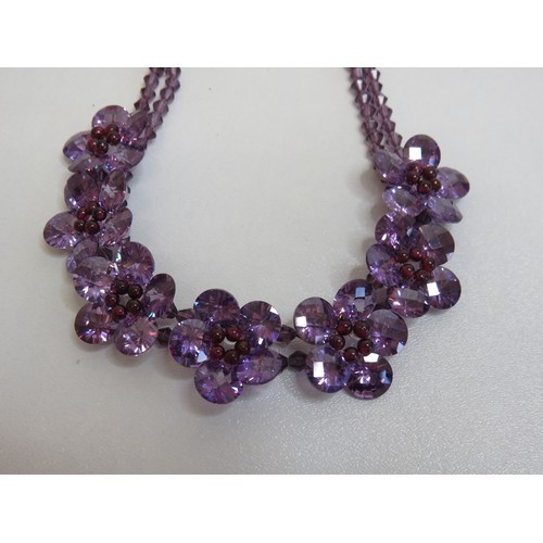 65 - Purple glass flower necklace.