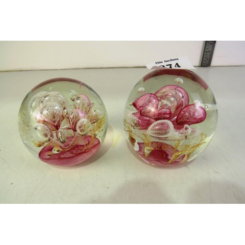 374 - Pair of pink murano style controlled bubbles paperweights