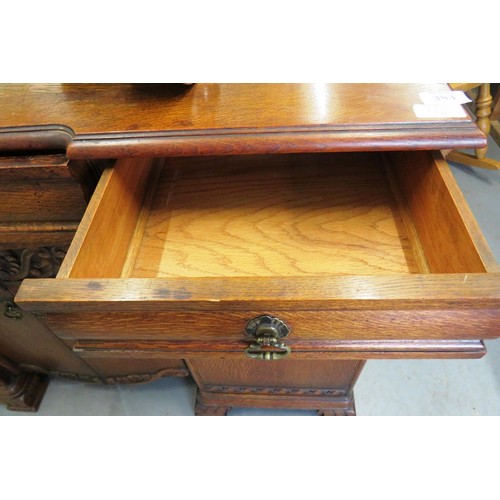 383 - 1930's carved oak sideboard with wine holder insert