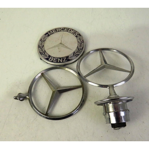 428 - Two Mercedes benz front hood ornament and a Mercedes wheel cup