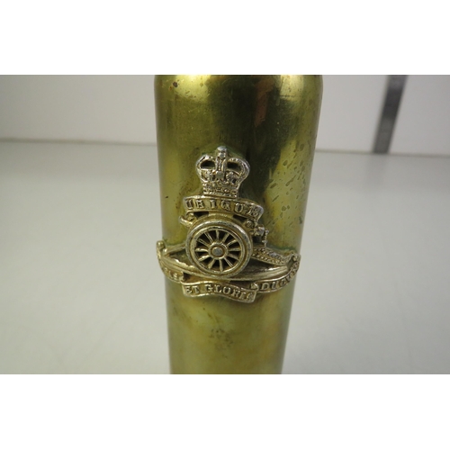 115 - Trench art shell with military badge