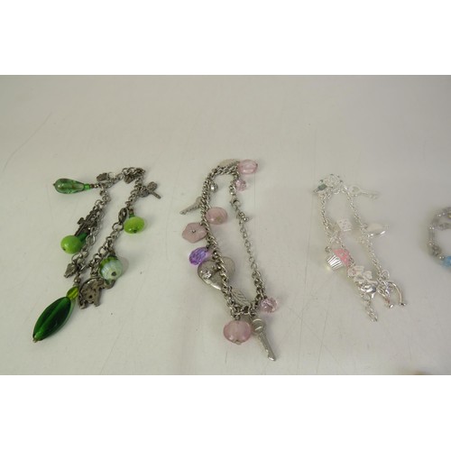 134 - Twelve charms bracelets including vintage